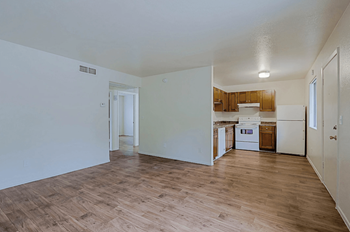 A kitchen with white appliances and wooden floors at Sahuaro West Phoenix, Arizona 85029